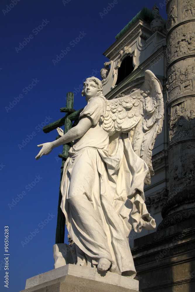 Angel statue in front of Karlskirche church in Vienna, Austria