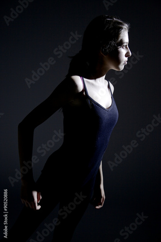 Ballerina exercising in the darkness