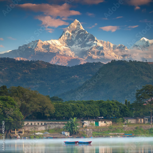 Never Ending Peace And Love. Two boats on a water and beautiful mountain peak on the background.  photo