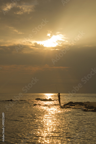 Landscape of sea and cloudy sky which has sun beam shine on sea water and beach in morning ; southern of Thailand