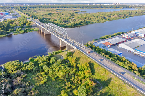 Traffic ob bridge through river. Tyumen. Russia