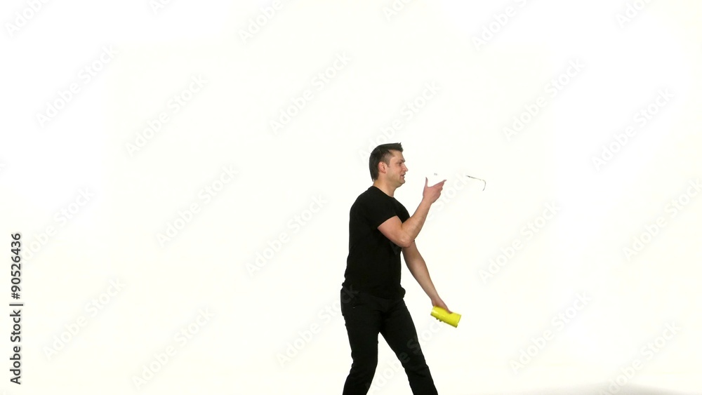 man bartender in black T-shirt does a trick with a shaker man bartender in black T-shirt does a trick with a shaker