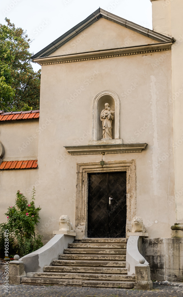 Side entrance and a statue of a saint Church of Archangel Michael Lviv, Ukraine