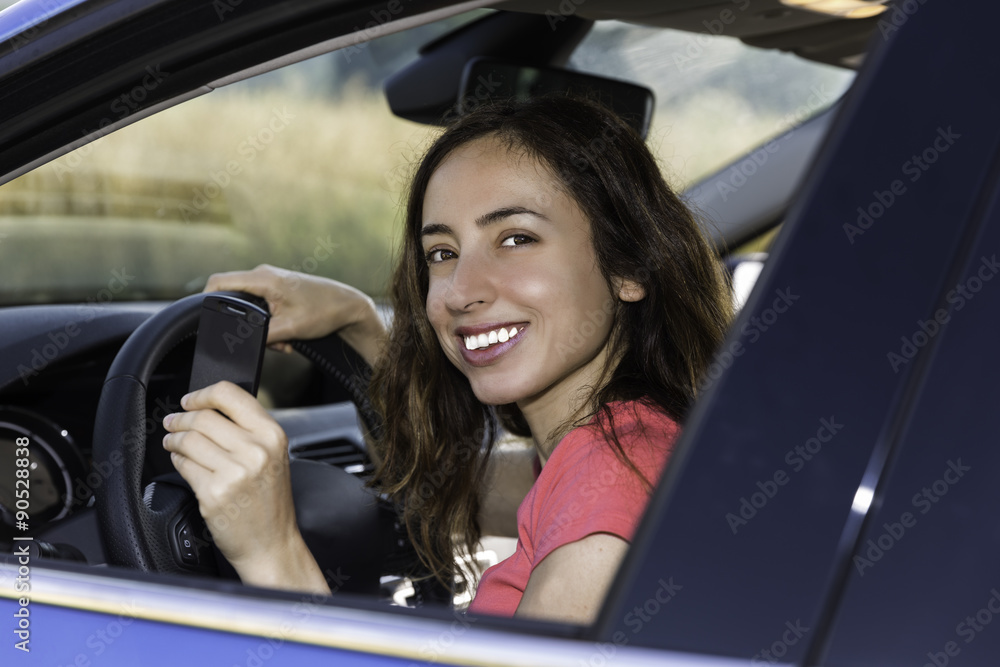 Happy female driver with car key in her hand