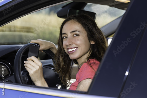 Happy female driver with car key in her hand