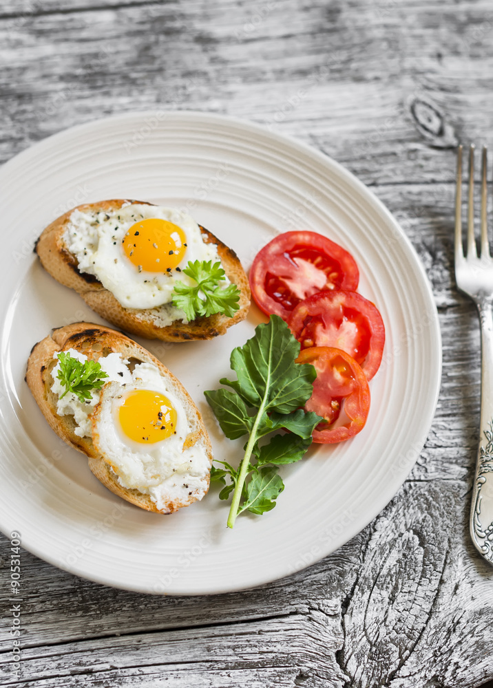 toast with soft cheese and quail eggs on a white plate on a light wooden background toast with soft cheese and quail eggs on a white plate on a light wooden background