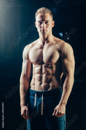Silhouette of a athlete. Confident young fitness man with strong © satyrenko