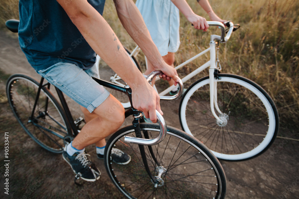 Naklejka premium young couple on vintage bikes riding