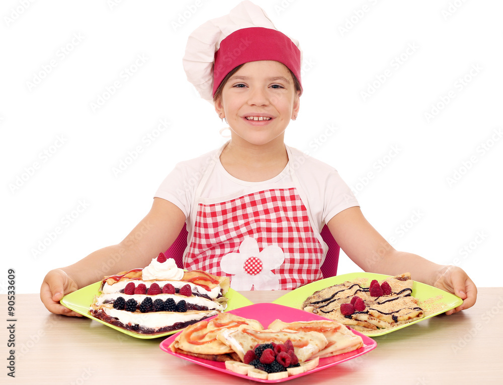 happy little girl cook with delicious crepes on table happy little girl cook with delicious crepes on table