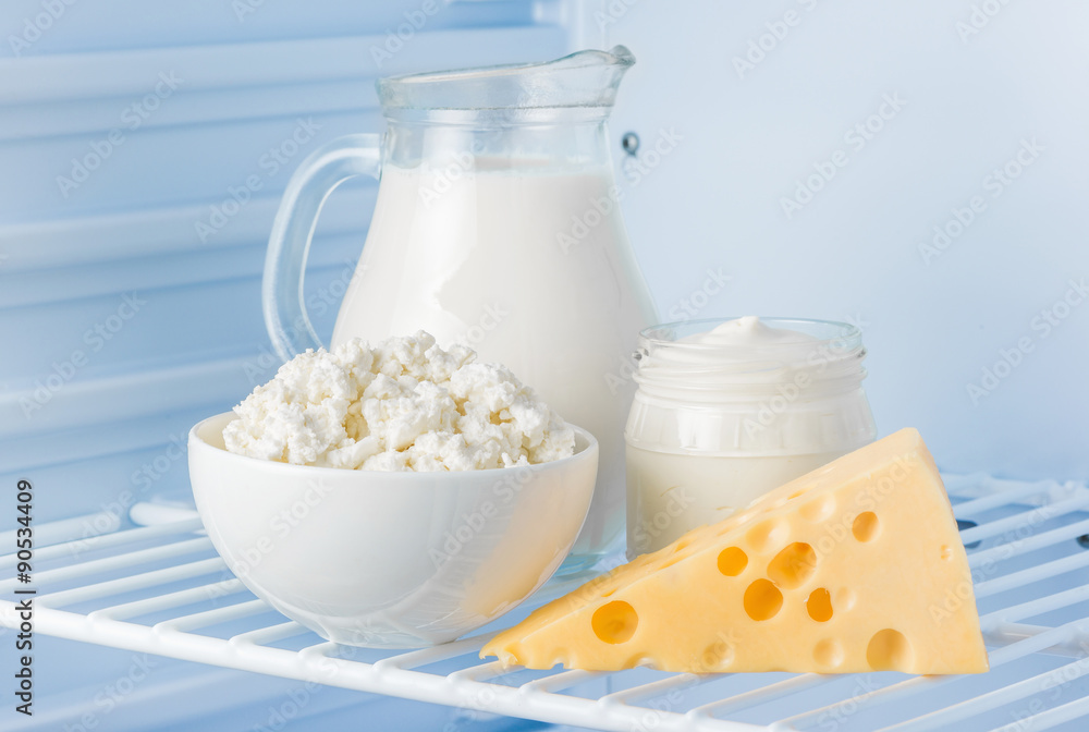 tasty healthy dairy products in the refrigerator: sour cream in the bank, cottage cheese in bowl, cheese and milk in a jar tasty healthy dairy products in the refrigerator: sour cream in the bank, cottage cheese in bowl, cheese and milk in a jar