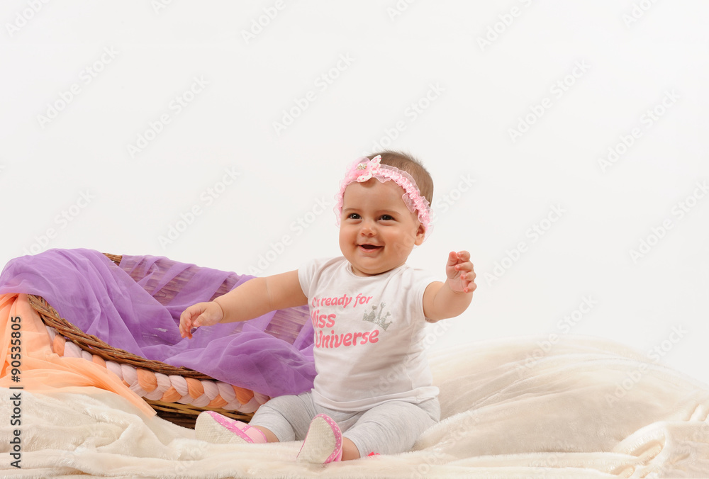 Cute and happy newborn baby playing, smiling, laughing with basket