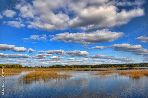 Landscape with big dark clouds. lake reflection clouds Latvia