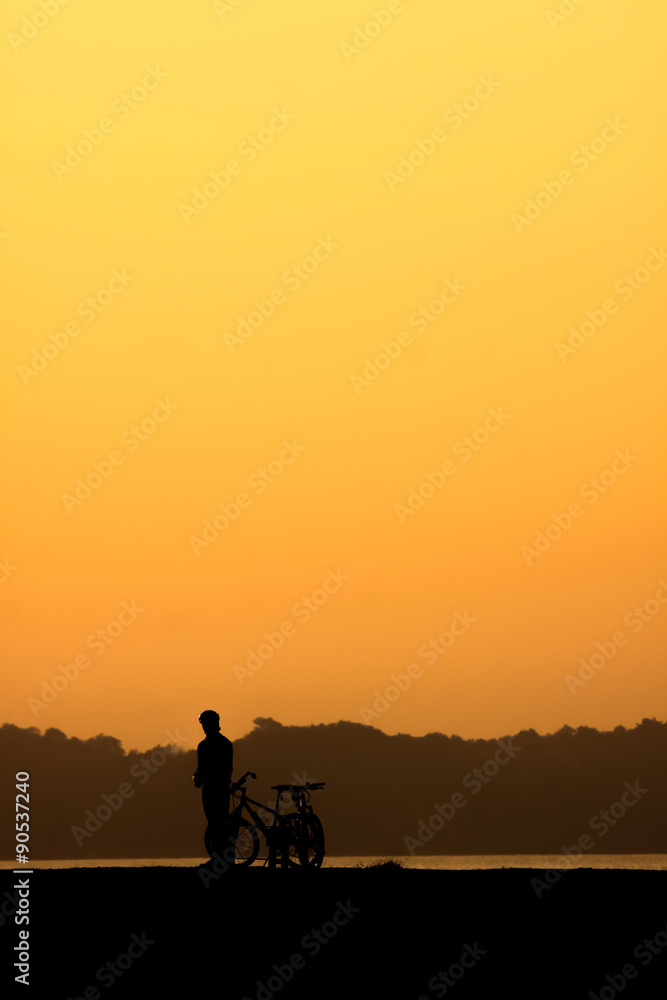 Silhouette of cyclist at sunset.