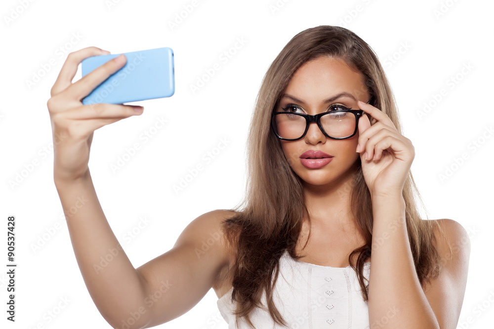 pretty girl with glasses make a selfie