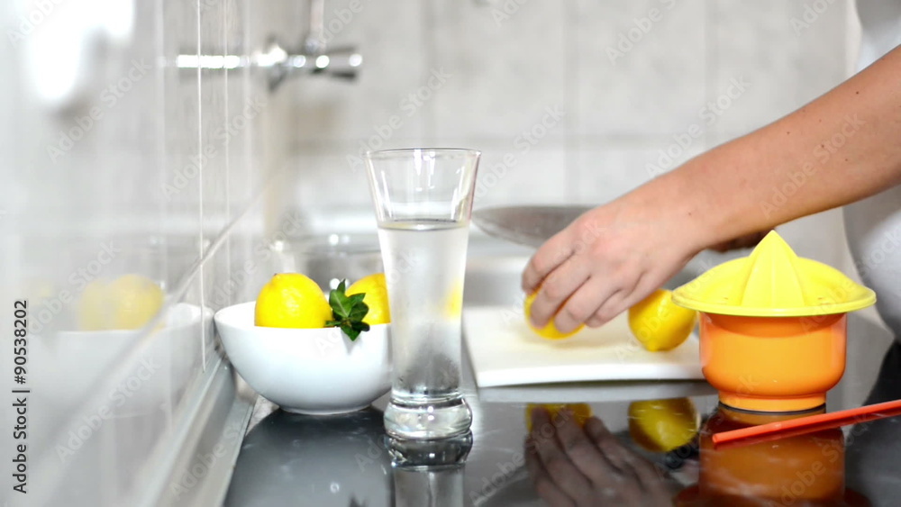 Fresh homemade lemonade.Woman making ice water lemonade in kitchen. Fresh homemade lemonade.Woman making ice water lemonade in kitchen.