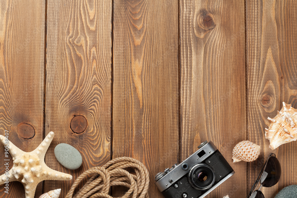 Travel and vacation items on wooden table Travel and vacation items on wooden table