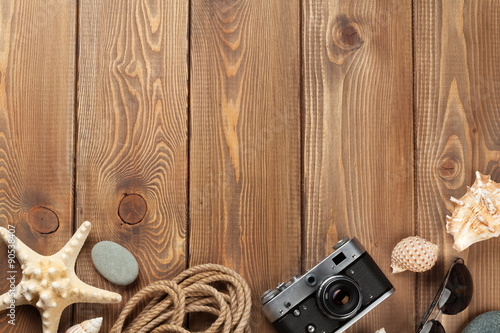 Travel and vacation items on wooden table