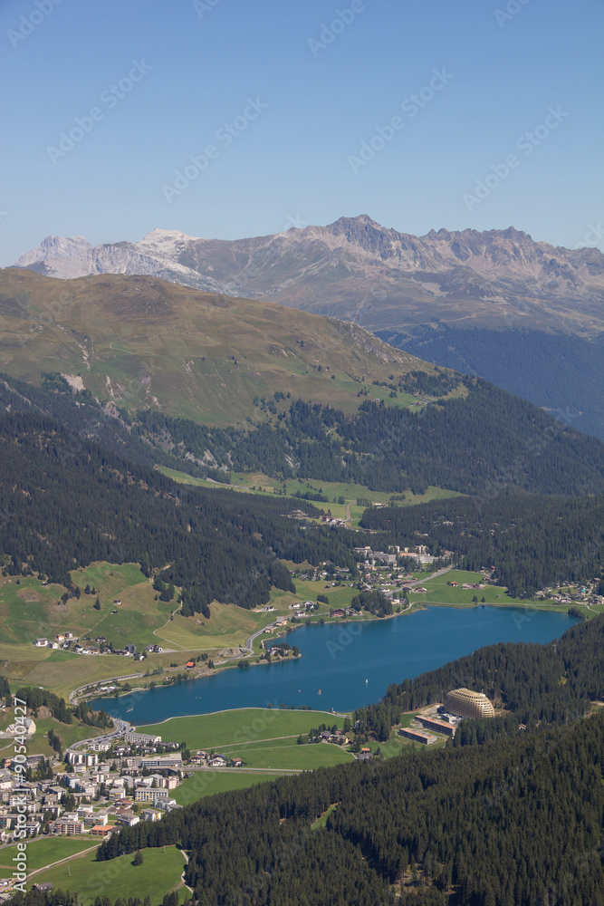 View From Mt. Jakobshorn Down To Davos & Lake Davos In Graubünden In Switzerland In Summer