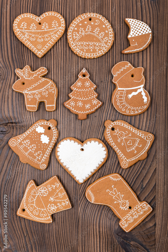Christmas Gingerbread. Home-baked and decorated gingerbread on wooden background.