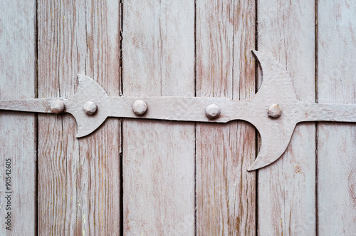Wooden door fragment with metal hinge © binik