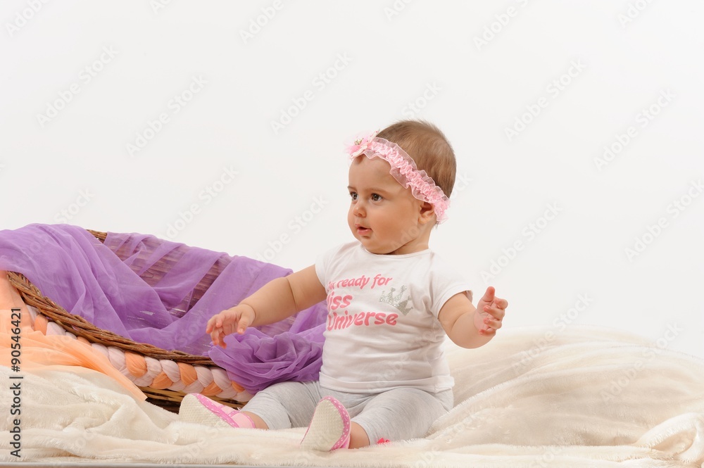 Fototapeta premium Cute and happy newborn baby playing, smiling, laughing with basket