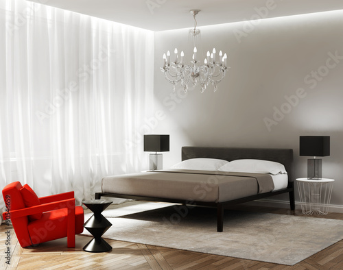 Modern grey bedroom with a red armchair photo