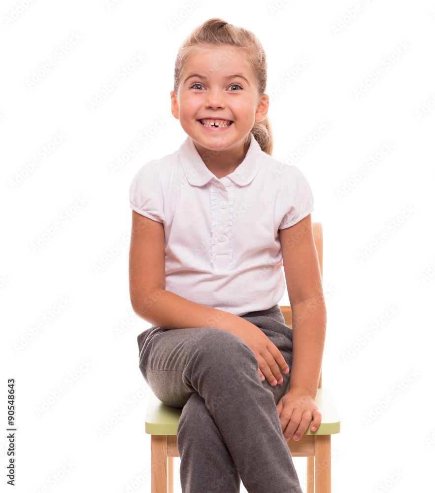 little girl sitting on a chair and smiling little girl sitting on a chair and smiling