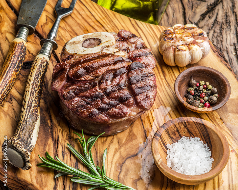 Beef steaks with spices on a wooden tray. Beef steaks with spices on a wooden tray.