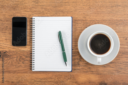 notebook  pen and Smartphone with cup of coffee