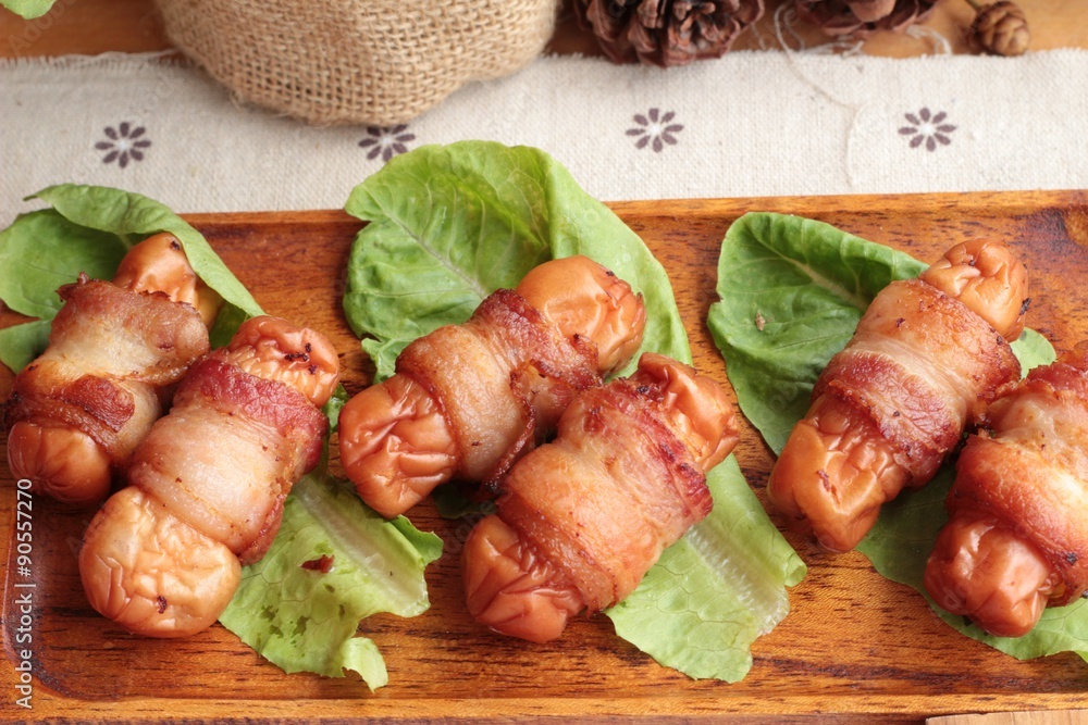 Grilled sausages wrapped in bacon fat of delicious. Grilled sausages wrapped in bacon fat of delicious.