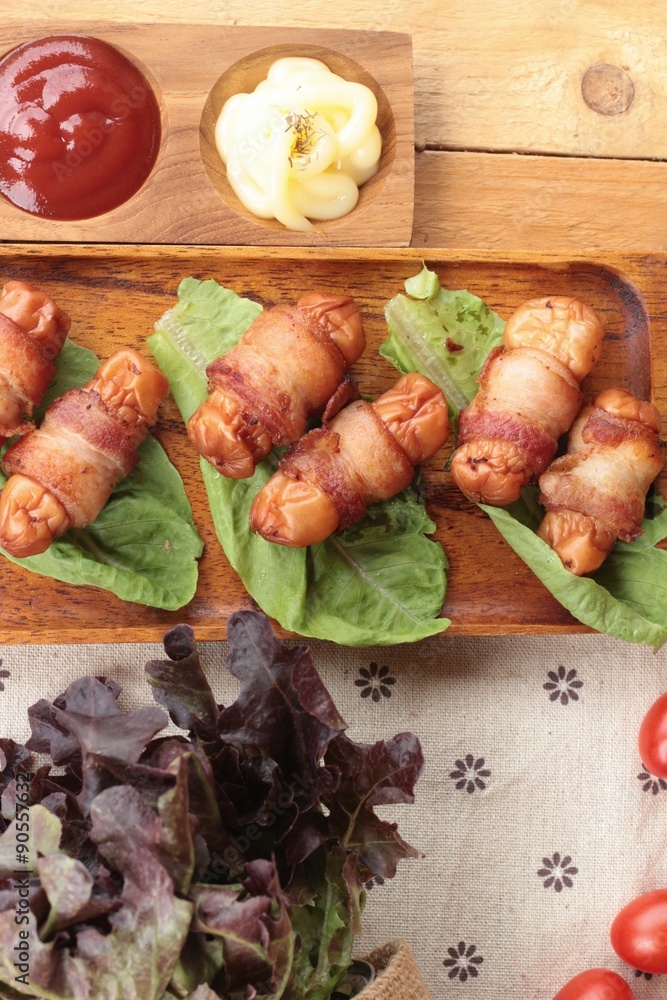 Grilled sausages wrapped in bacon fat of delicious. Grilled sausages wrapped in bacon fat of delicious.