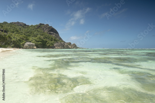 Paradise beach of Seychelles in la Digue island, Anse Source d'Argent. Boulders black granite rocks, turquoise water, white sand and blue sky. © albertraso