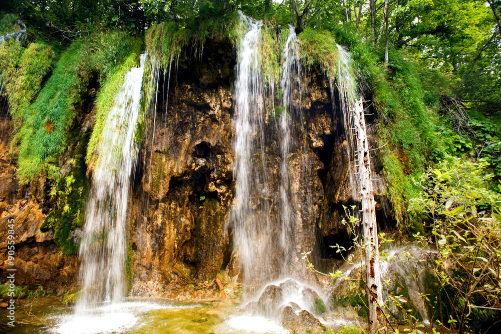 Fototapeta premium Breathtaking view of natural waterfall, lake cascade and water in deep tropical forest.