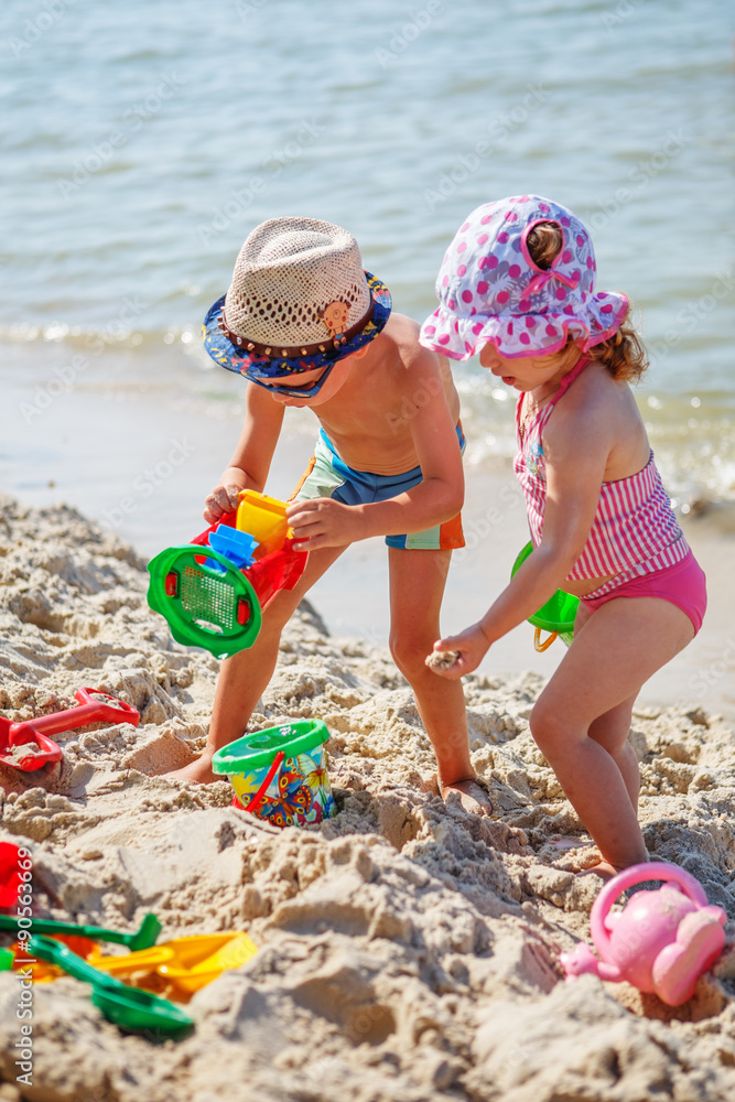 little girl and boy playing on the beach little girl and boy playing on the beach