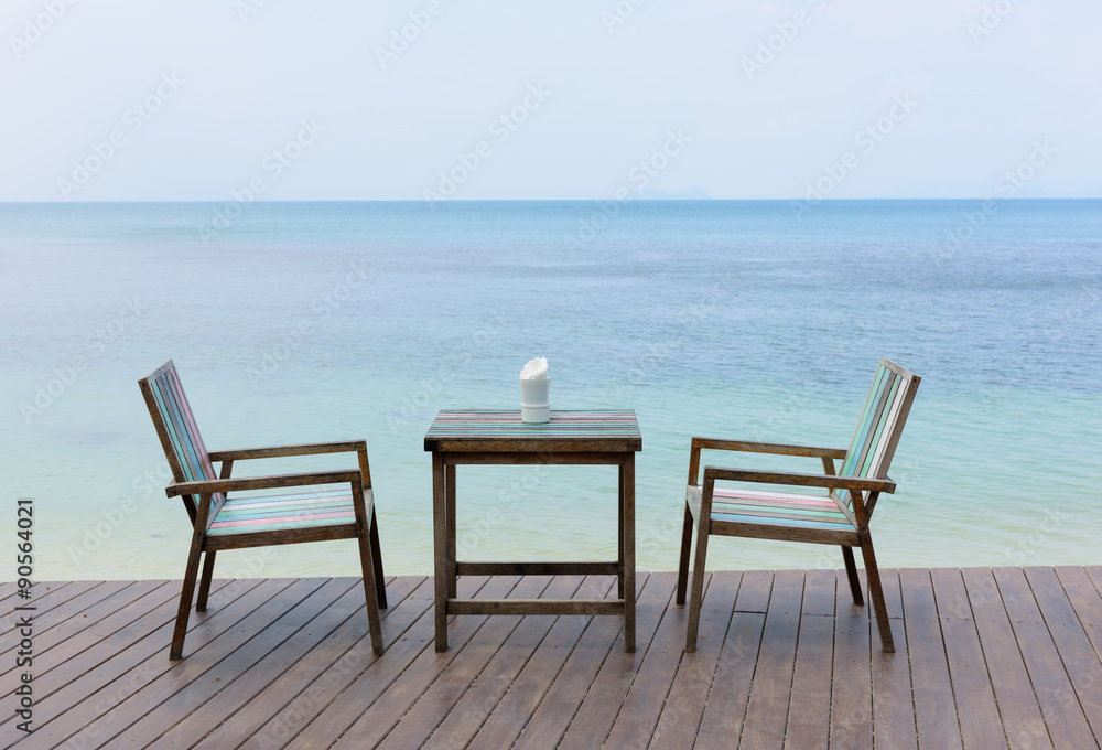 Fototapeta premium Wooden vintage table set with blue sky and sea background