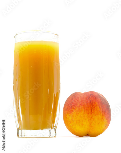 peach juice in a glass with a peach near isolated on white background