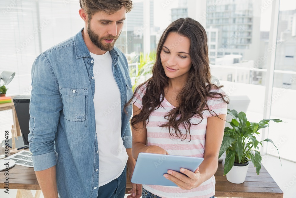 Casual business partners holding tablet Casual business partners holding tablet