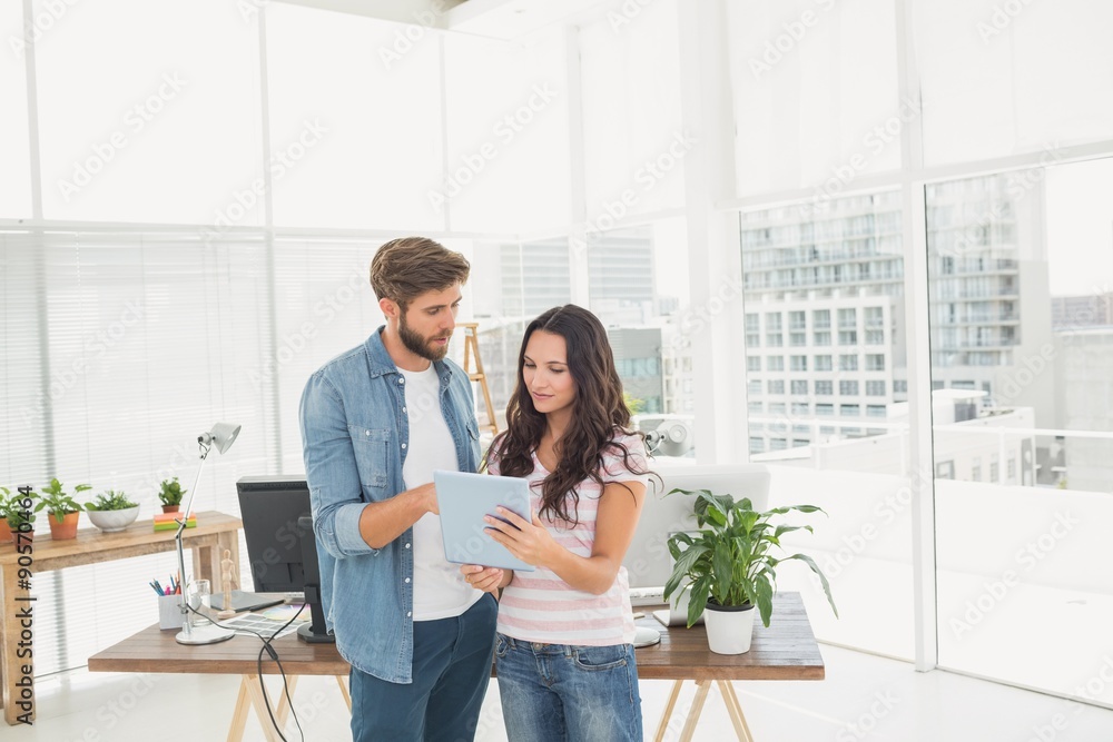 Casual business partners holding tablet Casual business partners holding tablet