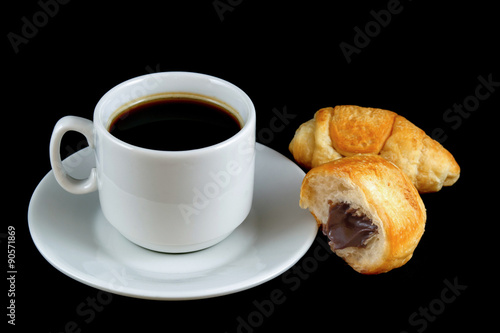 Fototapeta Naklejka Na Ścianę i Meble -  cup of coffee with a croissant  isolated on a black background

