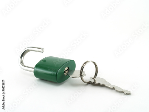 Fotografie close up silver key inserted into keyhole of old green padlock for unlock isolat