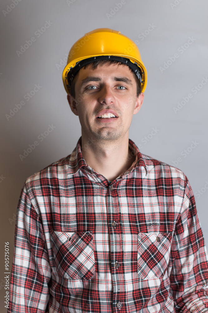 young man in a construction helmet, builder young man in a construction helmet, builder