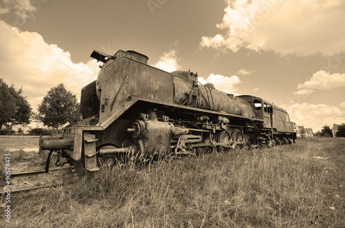 Scenic view of a vintage style picture of an ancient abandoned locomotive.