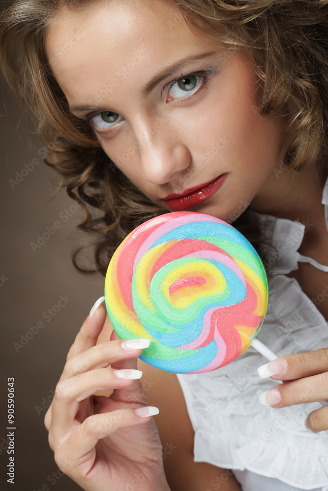 Young woman with colorful lollipop 