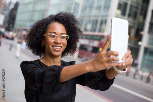 young woman taking a selfie in the city