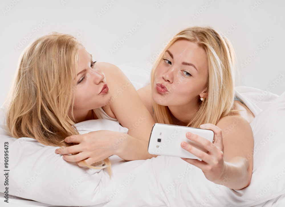 Smiling girls making selfie at home Smiling girls making selfie at home