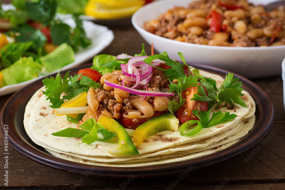 Mexican tacos with meat, beans and salsa