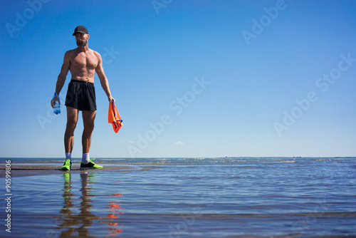 The man on the lake after running drinking water © razoomanetu