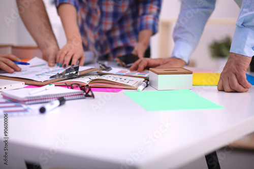 Close-up of three young creative designers working on project
