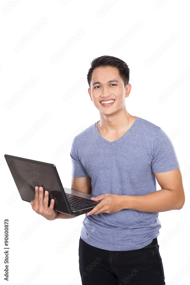 Young asian man standing with a laptop open, isolated Young asian man standing with a laptop open, isolated