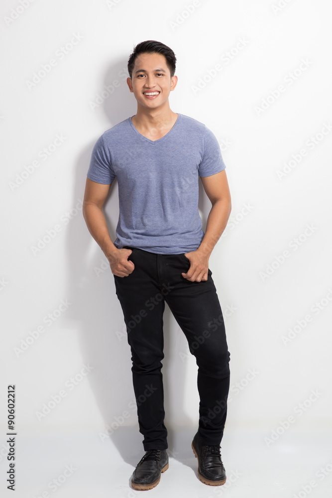happy Young asian man posing hands on the waist, smile to the ca happy Young asian man posing hands on the waist, smile to the ca